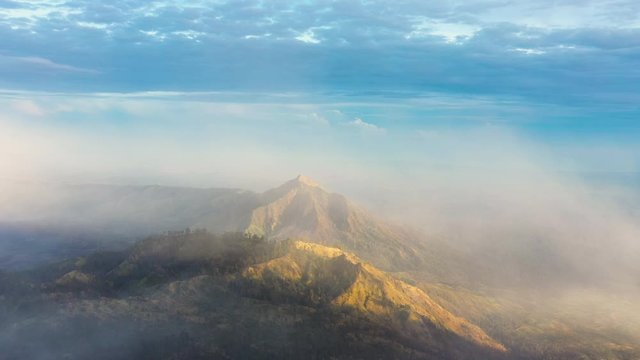 Stunning aerial view of a beautiful mountain range surrounded by clouds during sunrise. Ijen Volcano complex. The Ijen volcano complex is a group of composite volcanoes located in East Java, Indonesia