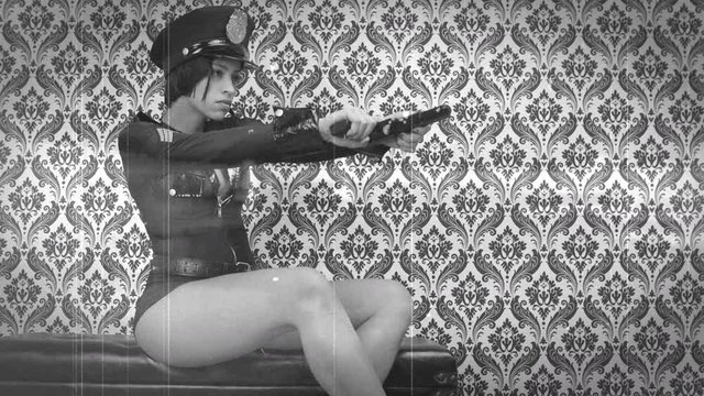 Scratched film of police woman dancing with pistol.