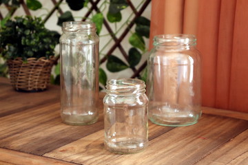 Three empty glass bottles of different sizes