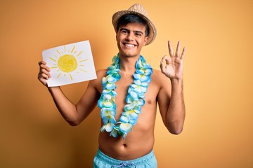 Tourist man on vacation wearing swimwear and hawaiian lei flowers holding banner with sun doing ok...