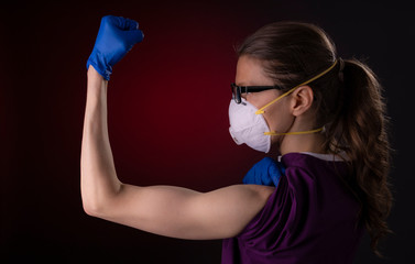 COVID-19 healthcare worker using PPE protective equipment showing strength