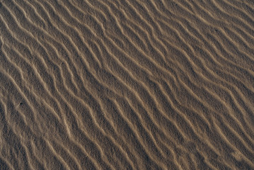 Sand beach Atlantic Ocean shore. Close up look at sand waves. Long Island beach with yellow sand and blue ocean. 