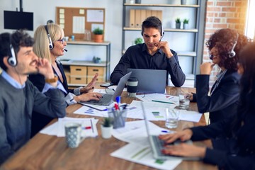 Group of call center workers smiling happy and confident. Working together with smile on face using headset at the office.