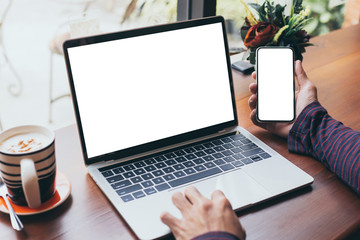 Fototapeta premium mockup image blank screen computer,cell phone with white background for advertising text,hand man using laptop texting mobile contact business search information on desk in cafe.marketing,design