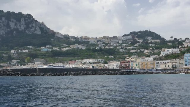 Tracking shot from the sea across the coastline of Capri island
