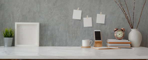 Cropped shot of comfortable workspace with smartphone, books, decorations and copy space