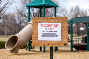 Playground sign advises of closure due to Coronavirus 