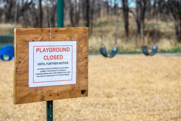 Playground sign advises of closure due to Coronavirus 