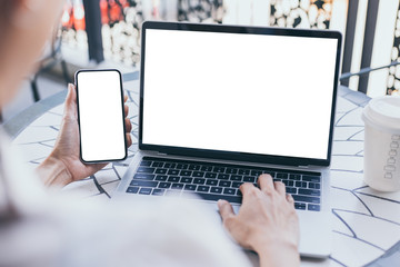 mockup image blank screen computer,cell phone with white background for advertising text,hand woman...