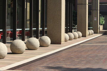 Modern concrete round sphere safety bollards in front of the Supreme Court of New South Wales...
