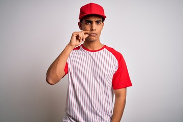 Young handsome african american sportsman wearing striped baseball t-shirt and cap mouth and lips...