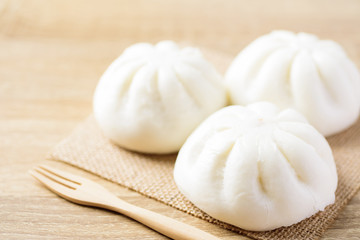 Fototapeta na wymiar Steamed buns stuffed with minced pork and fork ready to eating, Asian food