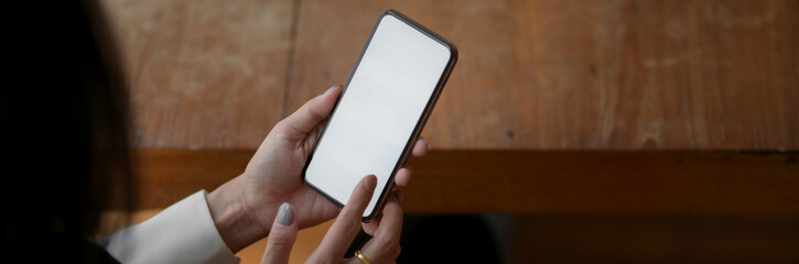 Close up view of female freelancer touching on blank screen smartphone