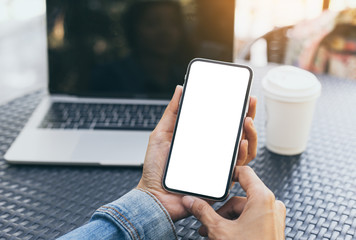 cell phone Mockup image blank white screen.woman hand holding texting using mobile on desk at coffee shop.background empty space for advertise text.people contact marketing business,technology