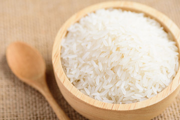 Organic Thai Jasmine rice grain in a bowl and spoon preparing for cooked	