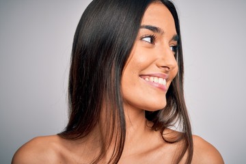 Close up of young beautiful woman with clear and pure skin. Perfect and clean skincare wearing natural makeup. Smiling happy looking fresh and healthy.