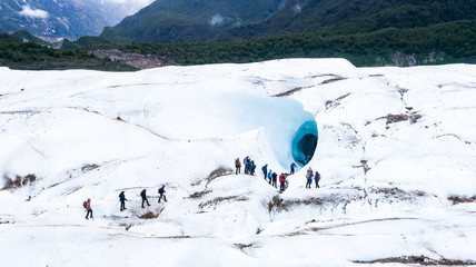People Walking on the Glacier Exploradores in Front of the Big Ice Cave, near Rio Tranquilo in Chilean Patagonia, Chile (06.01.2020)