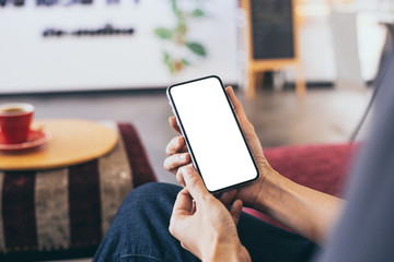 cell phone Mockup image blank white screen.woman hand holding texting using mobile on desk at coffee shop.background empty space for advertise text.people contact marketing business,technology