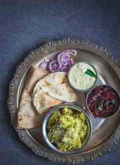 Indian thali with potatoes in chutney gravy
