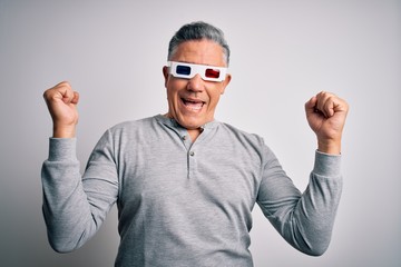 Middle age handsome grey-haired man using 3d glasses over isolated white background celebrating surprised and amazed for success with arms raised and open eyes. Winner concept.