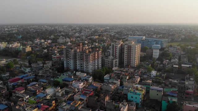 Dense indian city buildings skyscrappers at kolkata patuli municipality drone footage aerial view. point of view rotating shot slums of india old city.