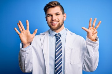 Young blond therapist man with beard and blue eyes wearing coat and tie over background showing and pointing up with fingers number nine while smiling confident and happy.