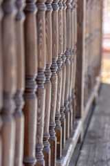 A row of balusters of a wooden veranda.