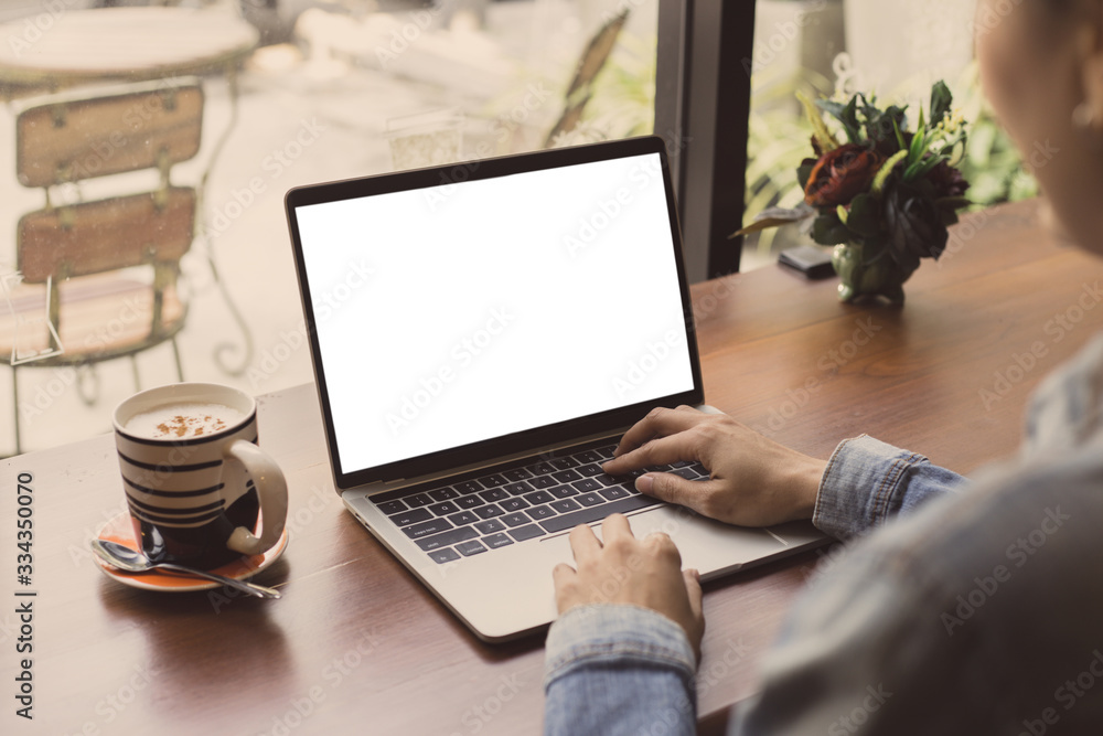 Wall mural computer mockup image blank screen with white background for advertising text,hand woman using lapto