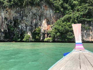 A boat sailing in the blue water of Krabi, Thailand