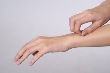 Close up hand of women scratch the itch with hand isolated on white background, Concept with...