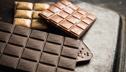 Chocolate bar on the rustic background. Selective focus. Shallow depth of field.