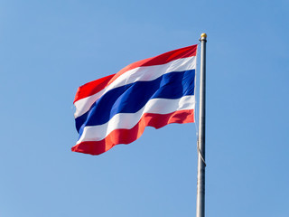 Thai flag on a blue sky background.