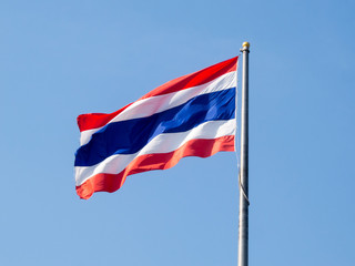 Thai flag on a blue sky background.