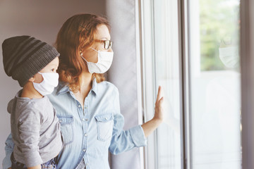 Coronavirus. Sick mother and her son looking through the window