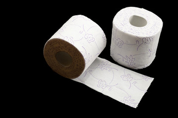 Tissue roll isolated on black. Toilet paper bathroom background. Cleaning concept product photograph for advertising