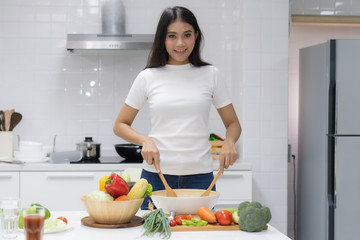 Eat healthy food for good wellness health concept. Woman cooking salad menu with fresh organic vegetables