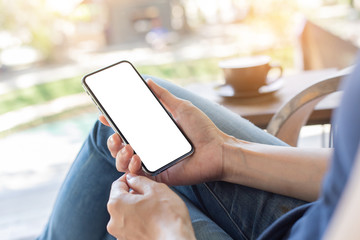 cell phone Mockup image blank white screen.woman hand holding texting using mobile on desk at coffee shop.background empty space for advertise text.people contact marketing business,technology