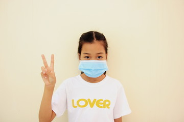 Children girl is protective surgical mask on their face and prevent Air pollution pm2.5 concept and Coronavirus Covid-19.