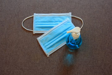 Surgical mask and Hand sanitizer gel for hand  protect covid-19 ,Blue mask on gray background.Placed everywhere of the house.