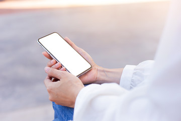 cell phone Mockup image blank white screen.woman hand holding texting using mobile on desk at coffee shop.background empty space for advertise text.people contact marketing business,technology