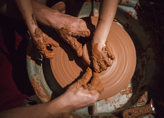 hands of potter on potters wheel