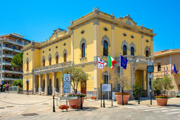 Obraz premium Olbia, Italy - Citi hall building - Municipio di Olbia - at the Corso Umberto I street - main boulevard and touristic site of the historic old town quarter