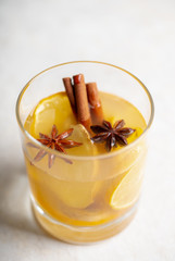 Healthy hot beverage with lemon, ginger and spices for protection in flu season. Selective focus. Shallow depth of field.