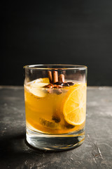 Healthy hot beverage with lemon, ginger and spices for protection in flu season. Selective focus. Shallow depth of field.