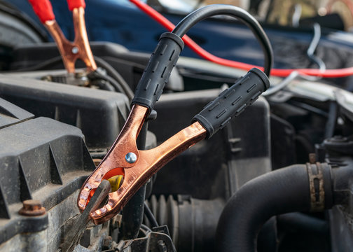 Jump Cables On Car Low Power Battery. Black And Red. Broken Car Start Attempt. Selective Focus.