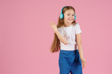 Dancing and singing. Teenager listen music. Recommended music based initial interest. Free music apps for mobile device. Energetic playlist. Girl cute schoolgirl white clothes headphones listen music.