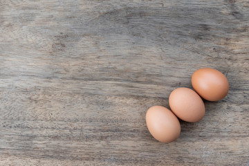 Close up chicken eggs on wooden table