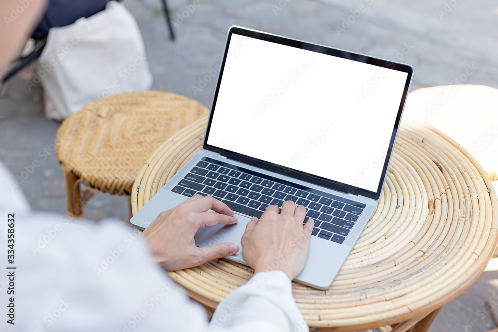 Wall mural computer mockup image blank screen with white background for advertising text,hand woman using lapto