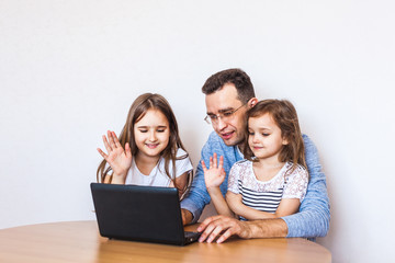 dad and daughter communicate via the Internet with their grandmothers and relatives, learning remotely, remotely, technology, coronavirus, home,