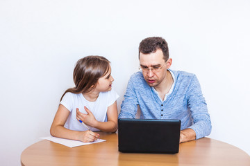 dad and daughter learn via the Internet, remote learning, family help, mom, relatives, time of...